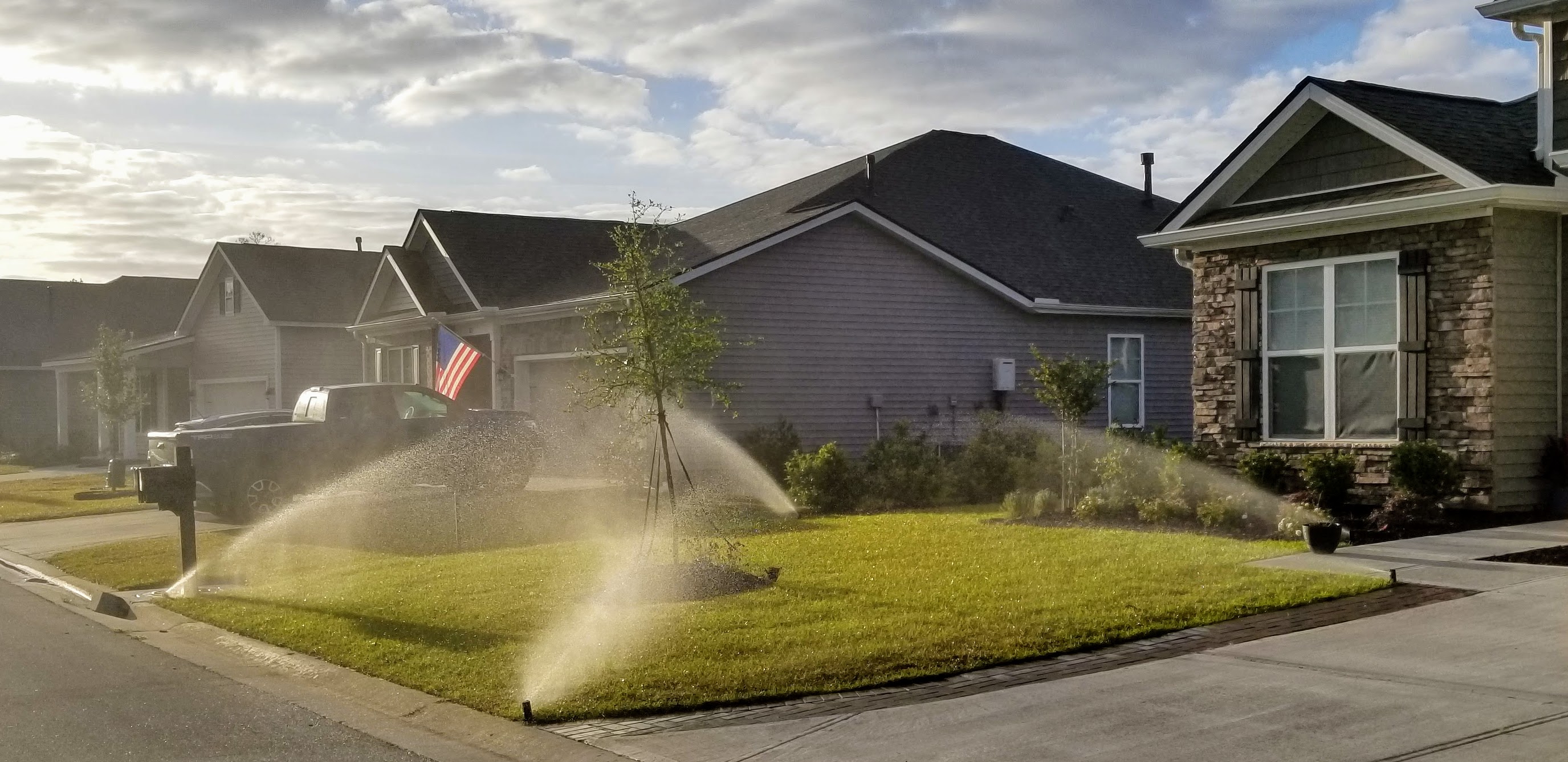 Irrigation sprinklers watering lawn